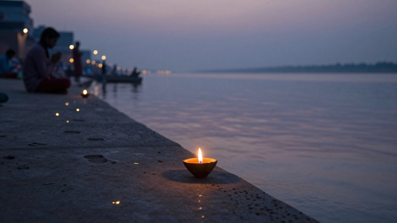 A single oil lamp glowing on a riverbank at dawn, reflecting in water with distant silhouettes.