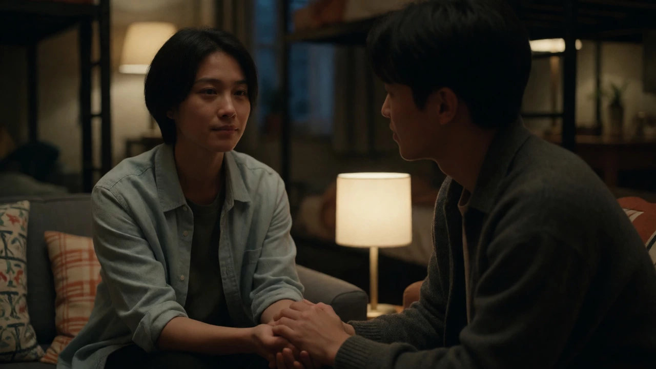 A friend comforting another who is crying in a dimly lit room
